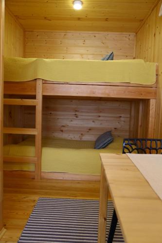 a bunk bed in a cabin with a table at Айбарка in Uznezya