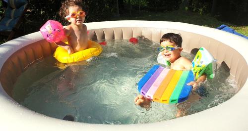two young boys in a pool with inflatables at La Meridiana House in Monterenzio