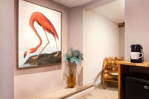 
a painting of a giraffe in a living room at The Queen's Inn in Hawkhurst
