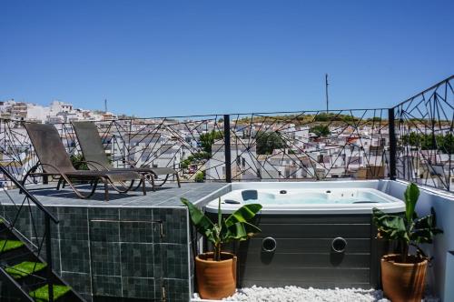 a hot tub on the roof of a house at Hotel Posada de las Cuevas in Arcos de la Frontera