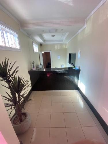 a living room with a plant in a pot at Star Hotel in Taguatinga