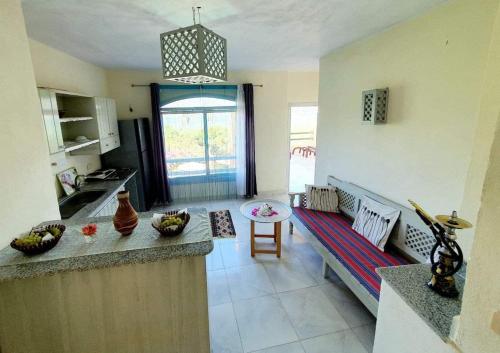 a kitchen with a counter and a table in a room at Nile Compound in Luxor