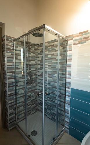 a shower with glass doors in a bathroom at Villa Piscinas in Piscinas