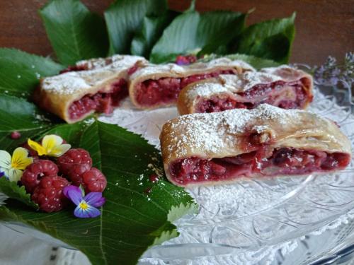 a glass plate with two puff pastry turnovers and berries at Villa Della Stua in Cormòns