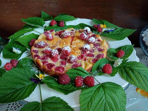 a cake with berries on it on a plate at Villa Della Stua in Cormòns