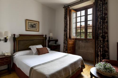 a bedroom with a large bed and a window at Parador de Cambados in Cambados