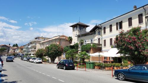 a city street with cars parked on the side of the road at Ex Convento Santa Caterina in Angera