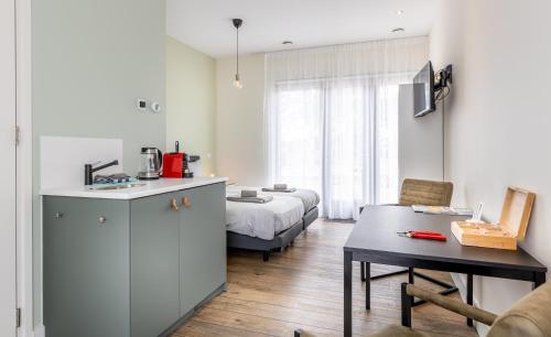 a living room with a bed and a table and a room at Singel 9 in Domburg