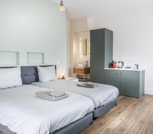 a bedroom with a large bed with white sheets at Singel 9 in Domburg