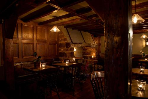 a restaurant with tables and chairs in a room at The Filly Inn in Brockenhurst