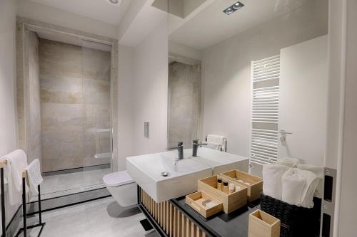 a bathroom with a white sink and a toilet at Nani Nani Boutique in Braşov