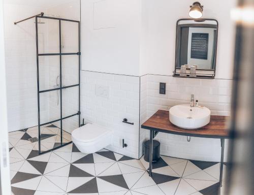 a bathroom with a sink and a toilet at Weekly Boardinghouse in Lohr am Main