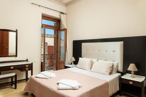 a bedroom with a bed and a sink and a mirror at Narkissos 'SUPERB' in Chania Town