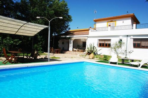 a swimming pool in front of a house at CampoParaíso Jaén-Casa Rural in Jaén
