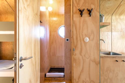 una ducha en una casa pequeña con lavabo en Stayokay Hostel Apeldoorn, en Apeldoorn