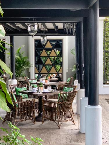 an outdoor patio with a table and chairs at The Siam in Bangkok