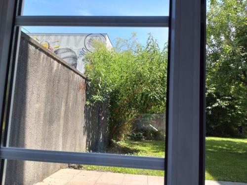a window with a view of a garden seen through it at Pension Elisabeth - Rooms & Apartments in Salzburg
