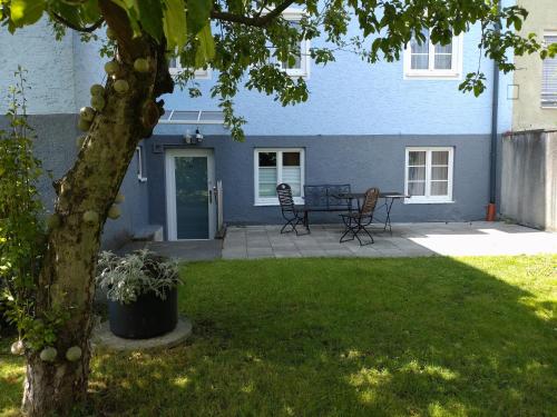 a patio with a table and chairs in a yard at Pension Elisabeth - Rooms & Apartments in Salzburg