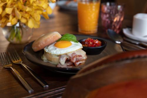 a plate of food with an egg on a table at The Siam in Bangkok