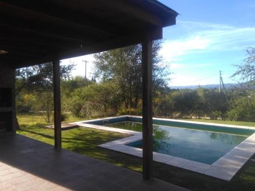 a view of a swimming pool from the patio of a house at Cabaña El Mirador de Bialet Masse in Villa Parque Siquiman