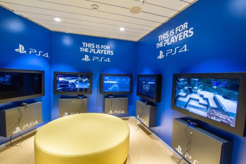 a room with a yellow chair and several televisions at Tallink Silja Line Ferry - Helsinki to Stockholm in Helsinki