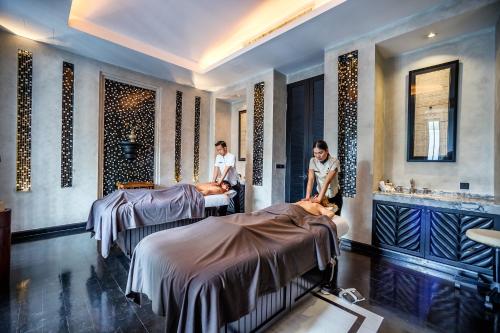 two people in a room with two beds at The Siam in Bangkok