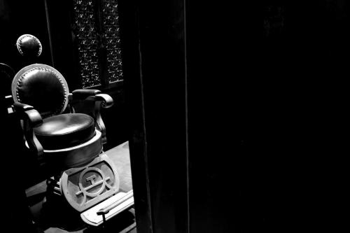 a chair sitting in a room with a drum at The Siam in Bangkok