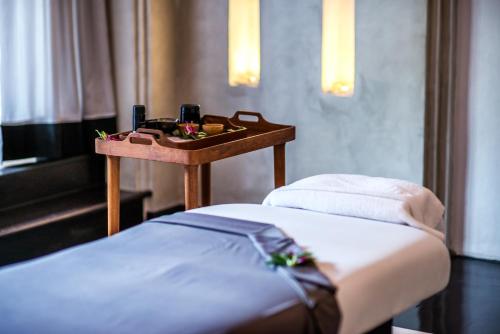 a room with two beds and a table with a tray at The Siam in Bangkok