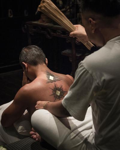 a man getting his hair cut by a woman at The Siam in Bangkok