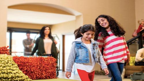 two girls walking in front of a pile of hay at Holiday Inn O'Hare Area by IHG in Rosemont