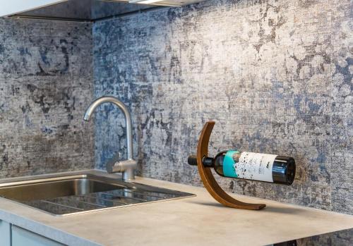 a bottle of wine is attached to a kitchen sink at Meduse Holiday IUNQ5361 in Cala Gonone