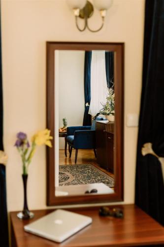 a mirror sitting on a desk in a room at Korona Pension and Restaurant in Hévíz