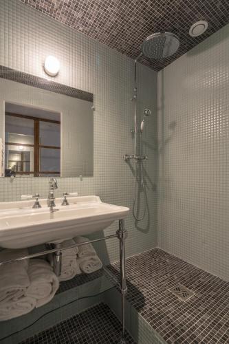 une salle de bain avec un lavabo et une douche dans l'établissement Pied A Terre Palestro, à Paris