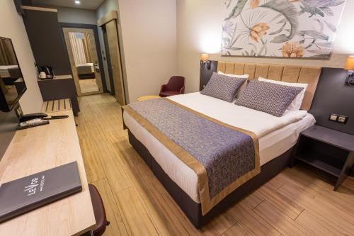 a hotel room with a bed and a desk at Levor Hotel in Bursa