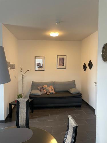 a living room with a couch and a table at An der Wurzel in Germeter