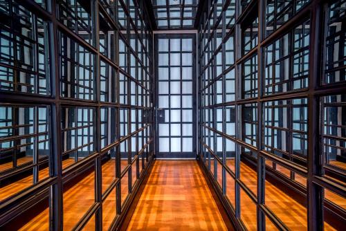 a large room with windows and a wooden floor at The Siam in Bangkok