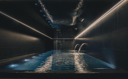 a dark bathroom with a pool of water at Hope Street Hotel in Liverpool