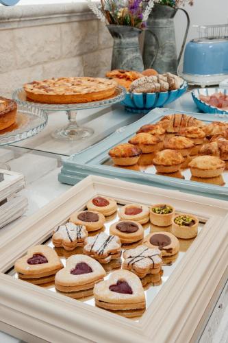 a buffet with various pastries and pies on display at B&B Casa di Anita in Arnesano