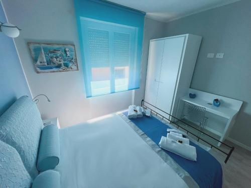 a bedroom with a large bed and a window at Las Floridas Apartment in Alghero