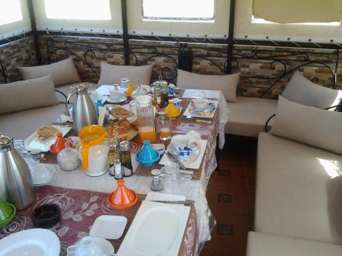 a room with a table with food and drinks on it at Riad Dar Mesouda in Tangier
