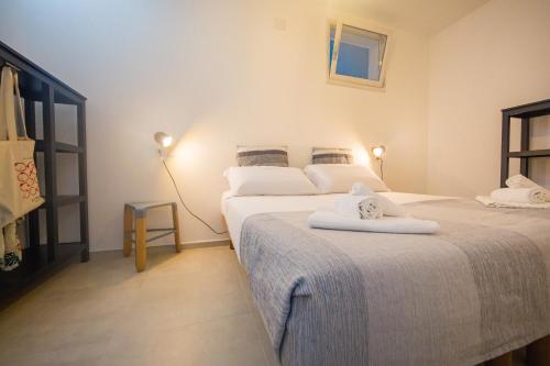 a bedroom with two beds with towels on them at Appartamento Oltremare IUNQ5361 in Cala Gonone