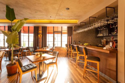 a restaurant with wooden tables and chairs and a bar at Levor Hotel in Bursa