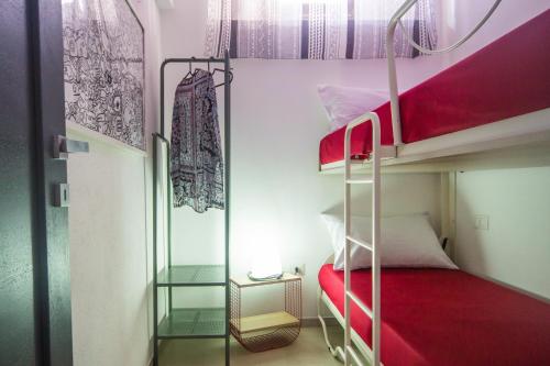 a bunk bed room with two bunk beds and a ladder at Meduse Holiday IUNQ5361 in Cala Gonone
