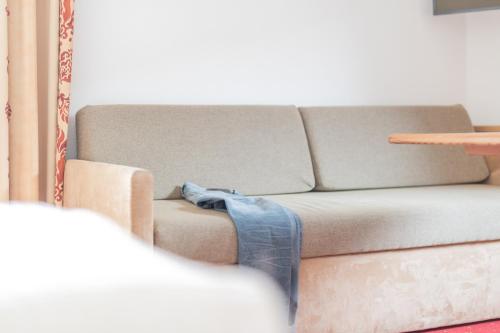 a living room with a couch and a table at Landhaus Fiegl in Sölden