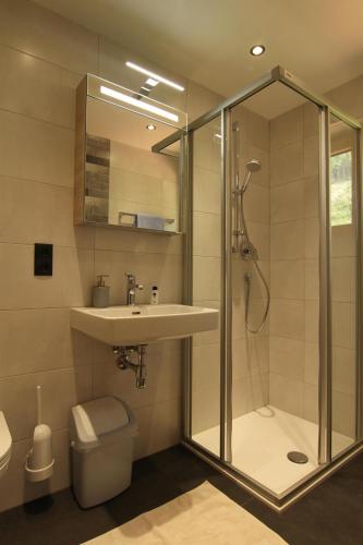 a bathroom with a shower and a sink and a toilet at Gästehaus Bliem in Mayrhofen