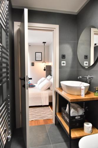 a bathroom with a tub and a sink and a bed at Lux Luna apartments & rooms Old town in Zadar