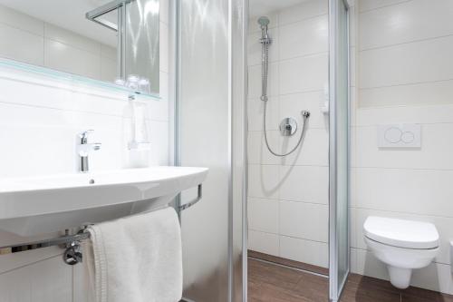 a bathroom with a toilet and a sink and a shower at Landhaus Fiegl in Sölden