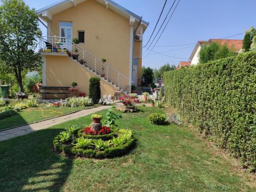 a garden in front of a house at Andrea Airport Apartments in Belgrade