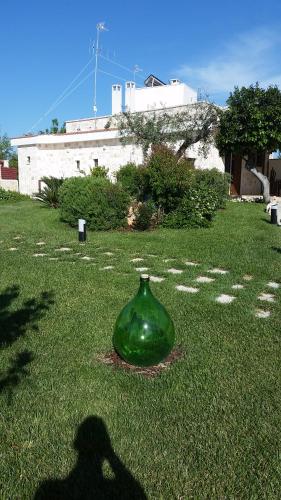 a green vase sitting on the grass in a yard at Villa Mest Pepp in Monopoli
