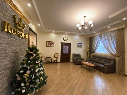 a living room with a christmas tree in it at Korona in Nalchik